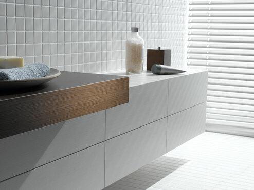 Detailaufnahme eines weißen Waschtischunterschrankes mit dunkler Waschtischplatte